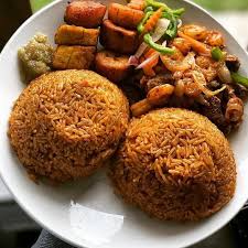 Family-style dinner table with shared dishes and rice in the center